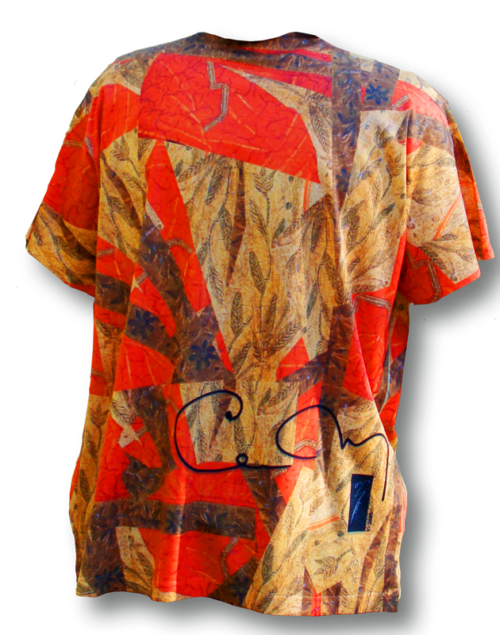 A person wearing an orange shirt with leaves on it.