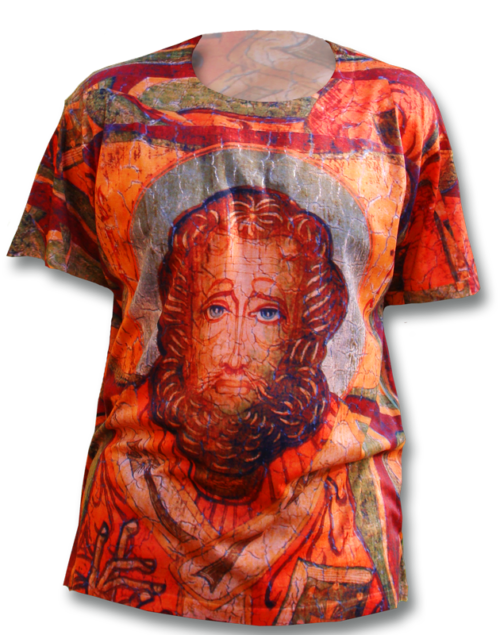 A person wearing an orange shirt with a painting of a man 's face.