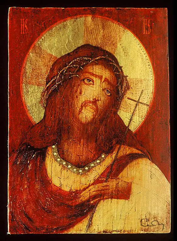 A painting of jesus holding the cross.