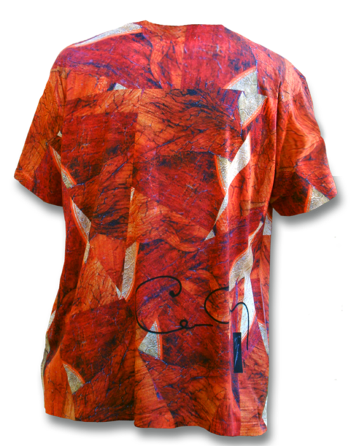 A person wearing an orange shirt with red and white leaves.